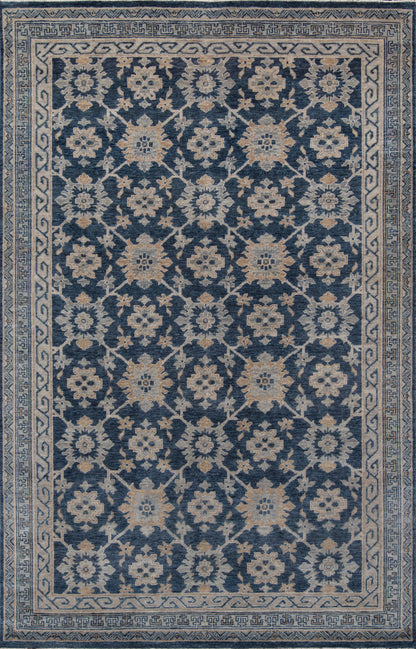 Blue floral oriental rug with ivory blossoms on deep indigo field; light geometric border.