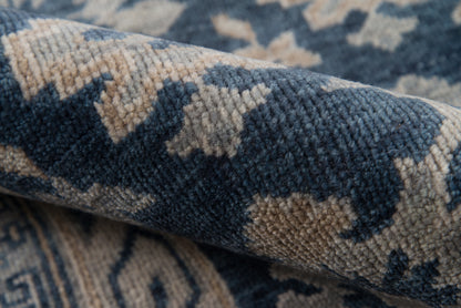 Blue and beige geometric patterned rug with a soft woven texture, close-up.