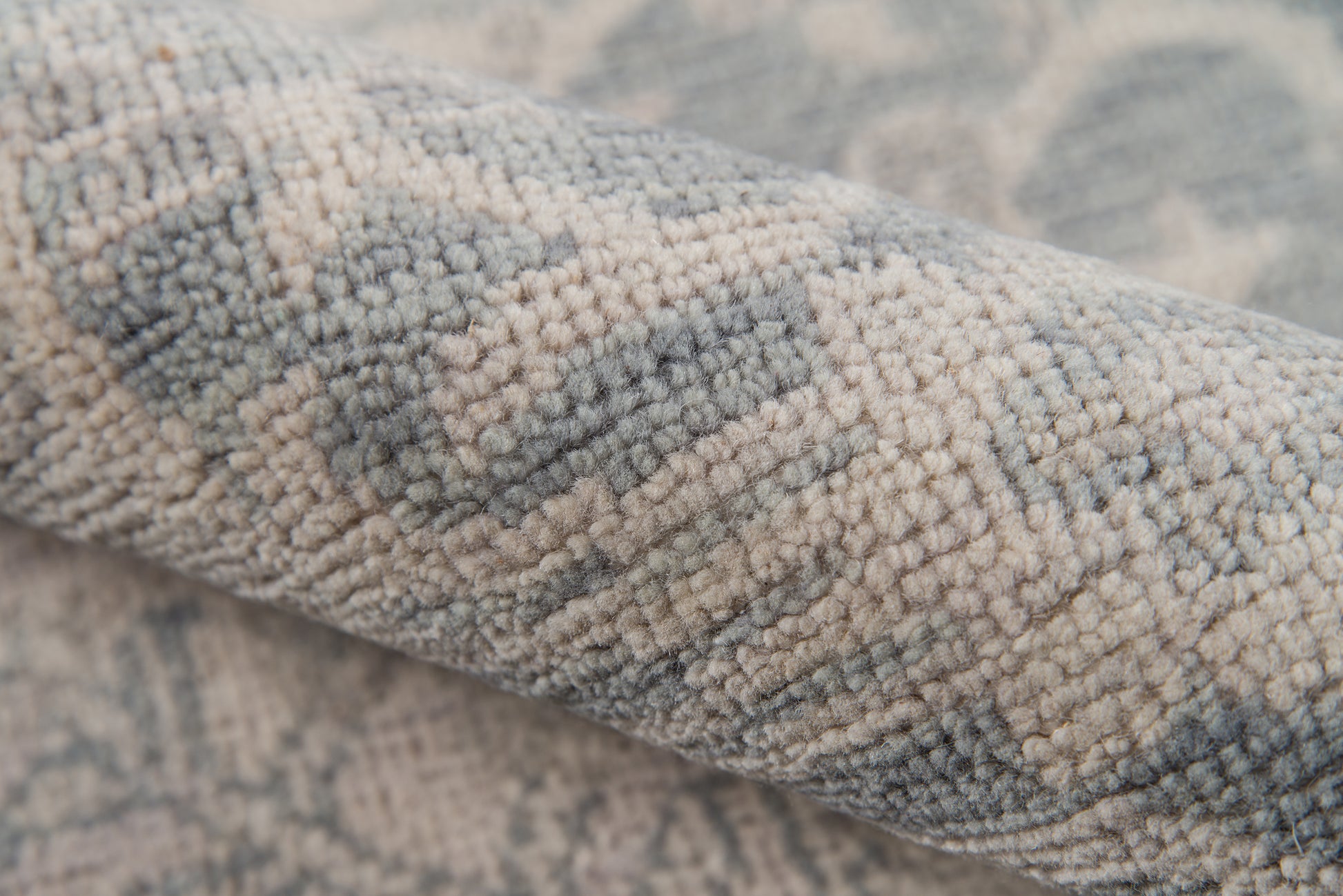 Soft blue and beige textured rug with geometric weave; plush boucle piles for a cozy living room.