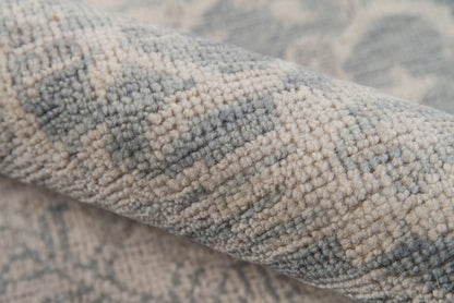 Soft blue and beige textured rug with geometric weave; plush boucle piles for a cozy living room.