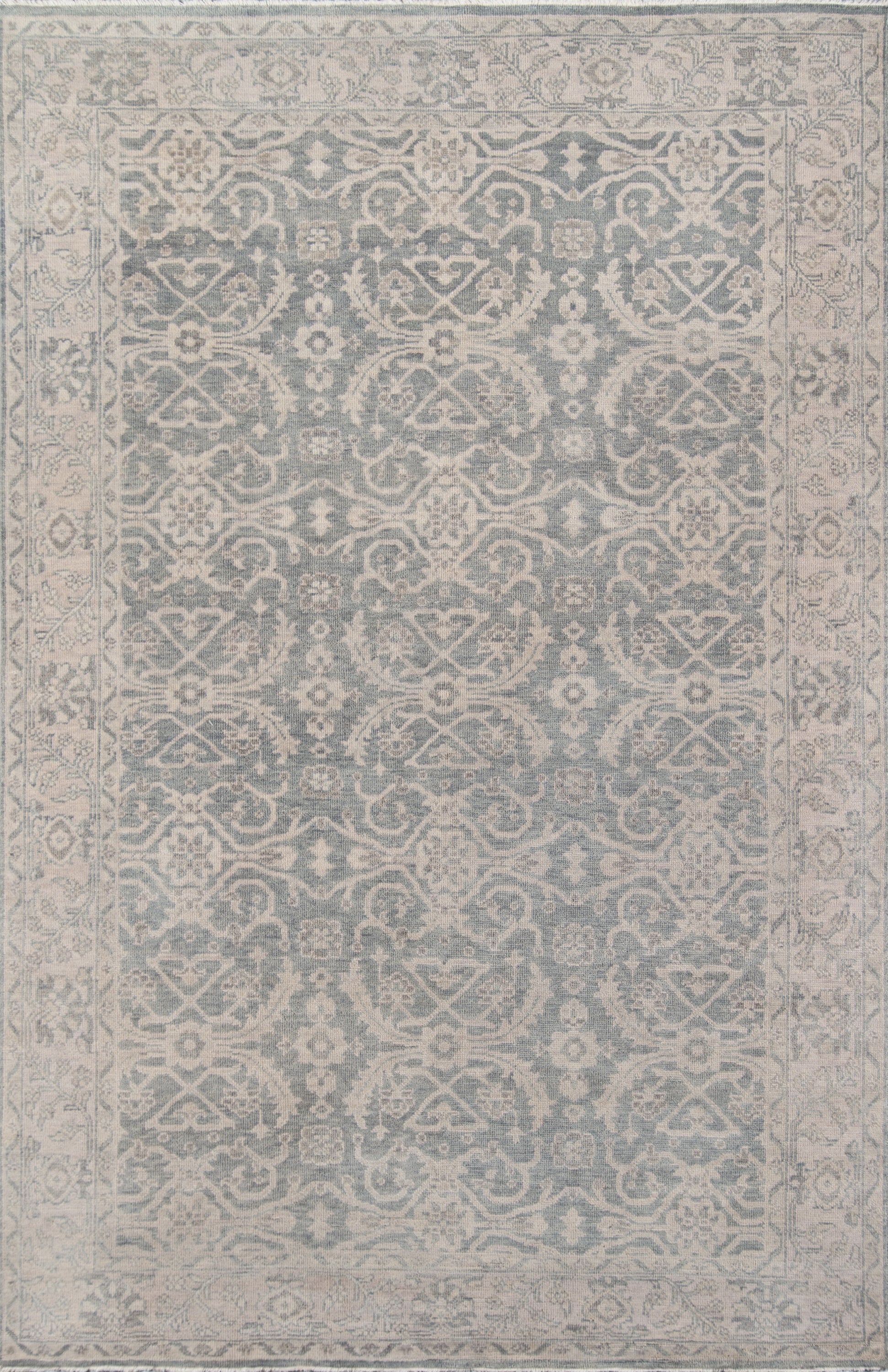 Blue-gray oriental area rug with ivory floral arabesque motifs and a decorative border.