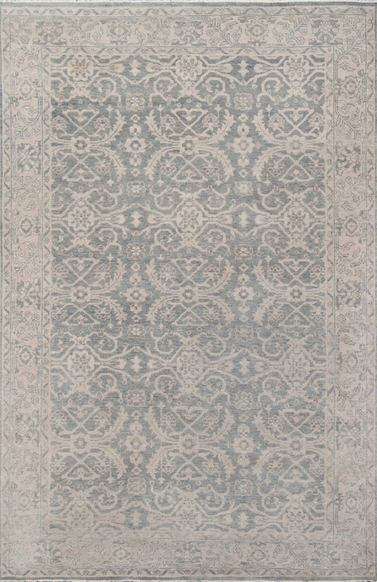 Persian-inspired blue-gray area rug with ivory floral damask pattern and decorative border; soft woven texture.