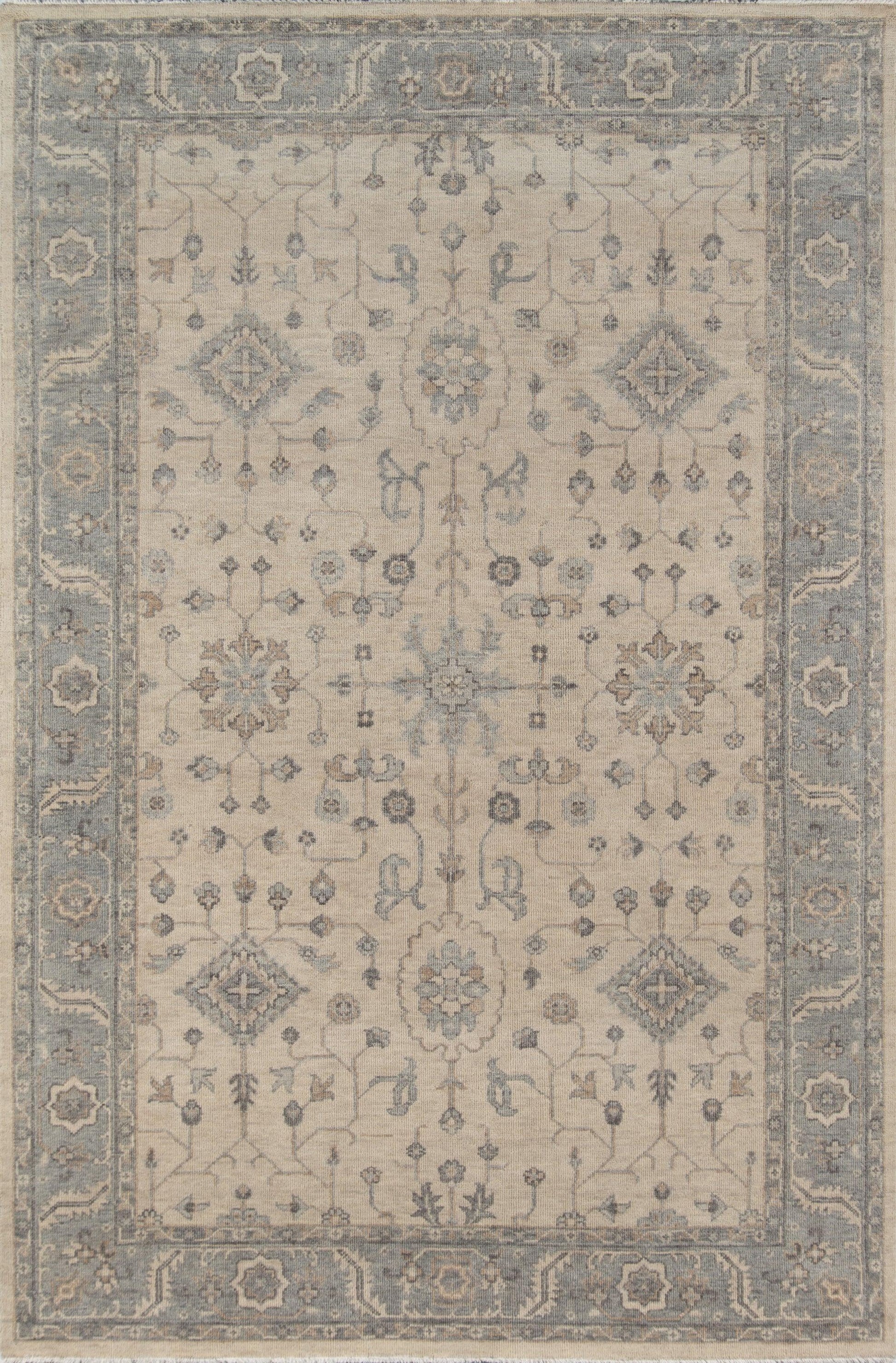 Beige oriental area rug with muted blue border and floral medallions; vintage Persian-inspired design.