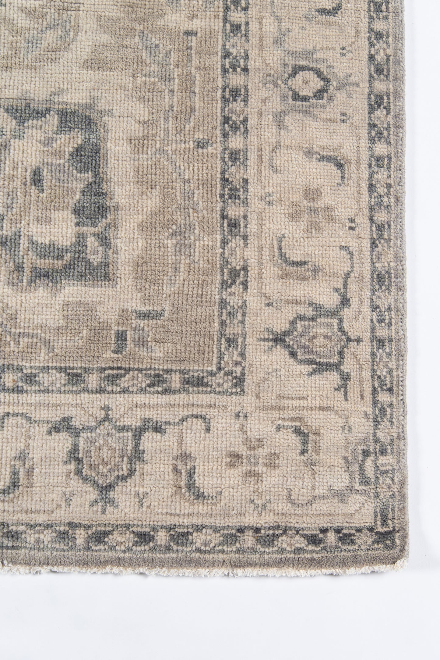 Beige and gray distressed woven rug with blue-gray border and vintage floral-medallion design.