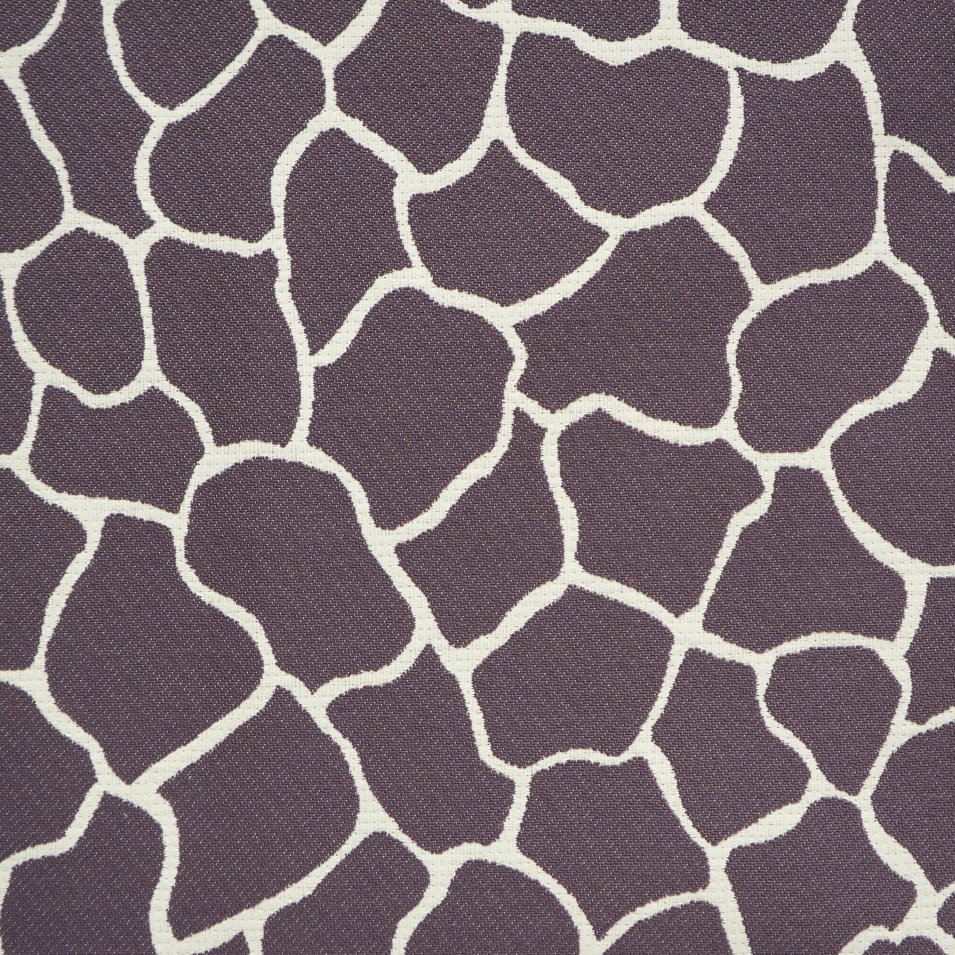 Purple upholstery fabric with cream irregular spots forming a giraffe-like mosaic pattern, textured weave.