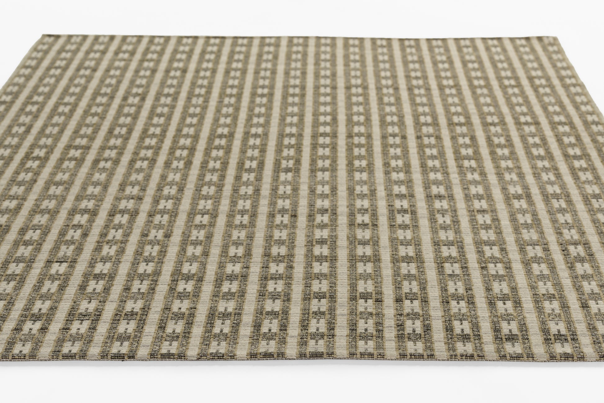Rectangular flatwoven rug in beige, taupe and gray with vertical geometric stripe motifs for modern living spaces.
