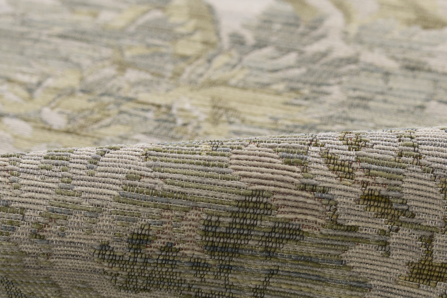 Muted olive, beige and cream floral tapestry weave; woven rug texture with folded edge.