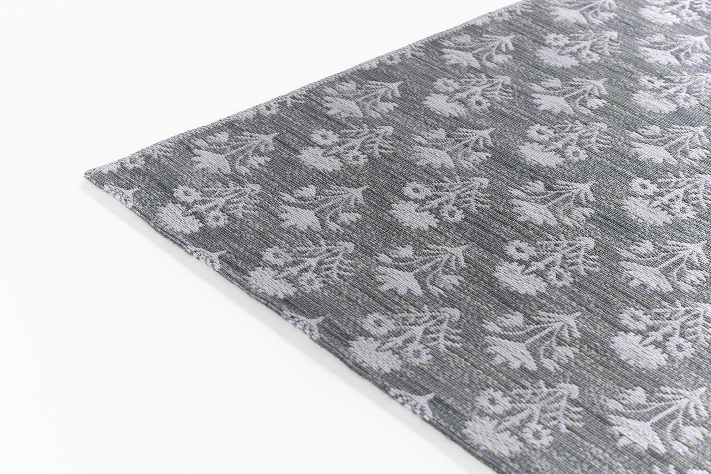 Gray woven rug with white floral damask pattern, rectangular, textured textile for modern living rooms.
