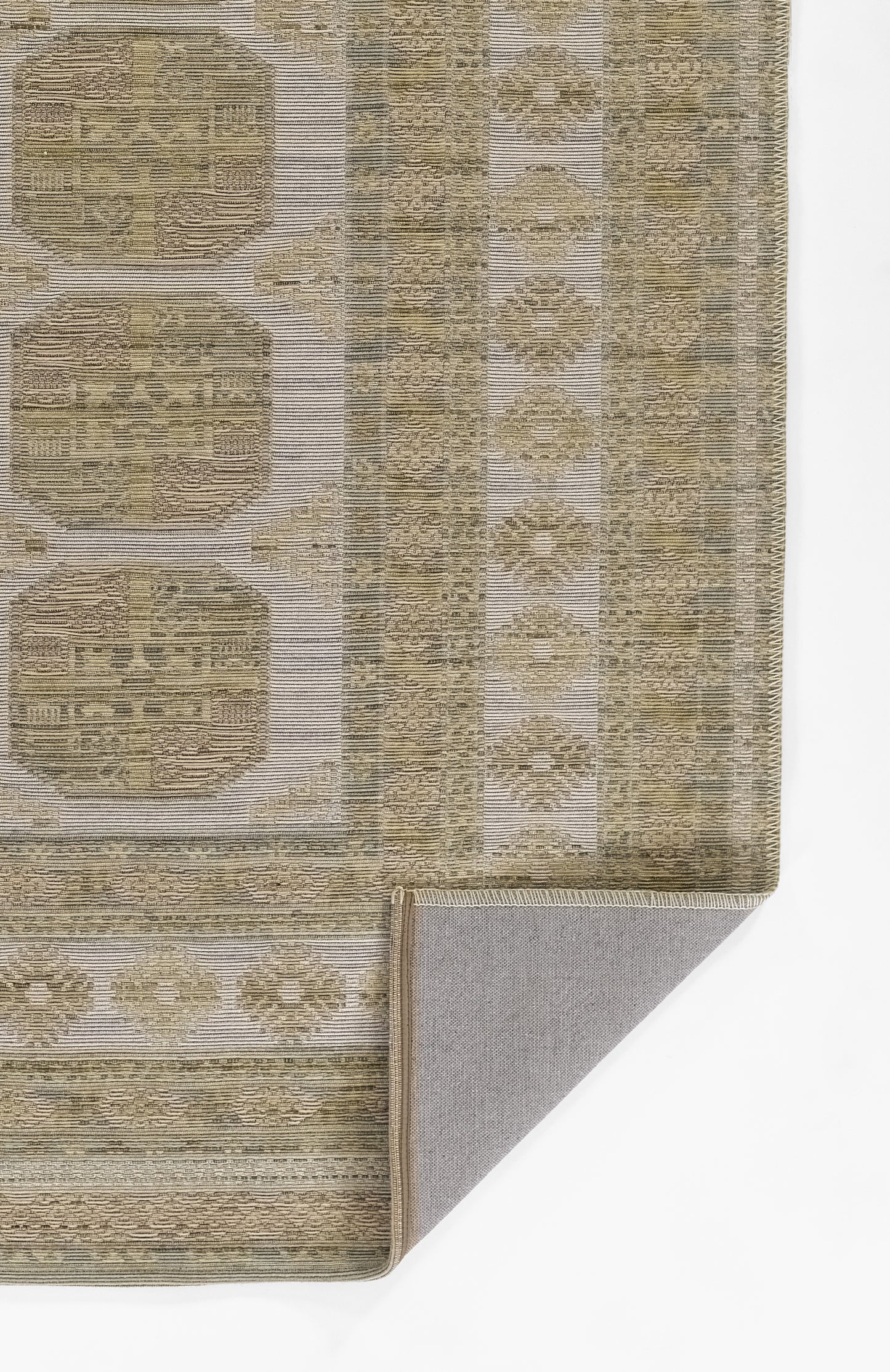Beige-brown oriental rug with circular medallions, subtle borders, woven texture, folded corner showing grey backing.