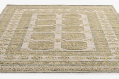 Rectangular beige cream flatweave rug with pale gold center blocks and blue-gray bordered geometric floral borders.