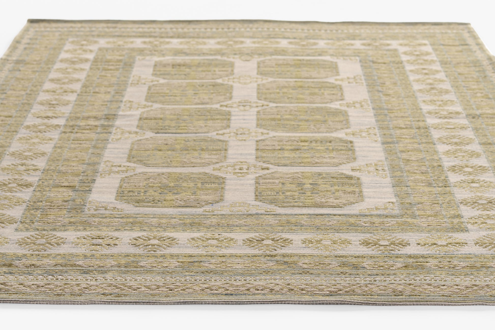 Neutral beige-taupe flat-weave rug with pale blue-gray borders and repeating geometric panel motifs.