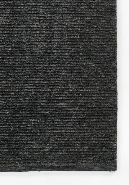 Charcoal gray loop-pile rug close-up with dense texture and horizontal ridges, rectangular floor mat.