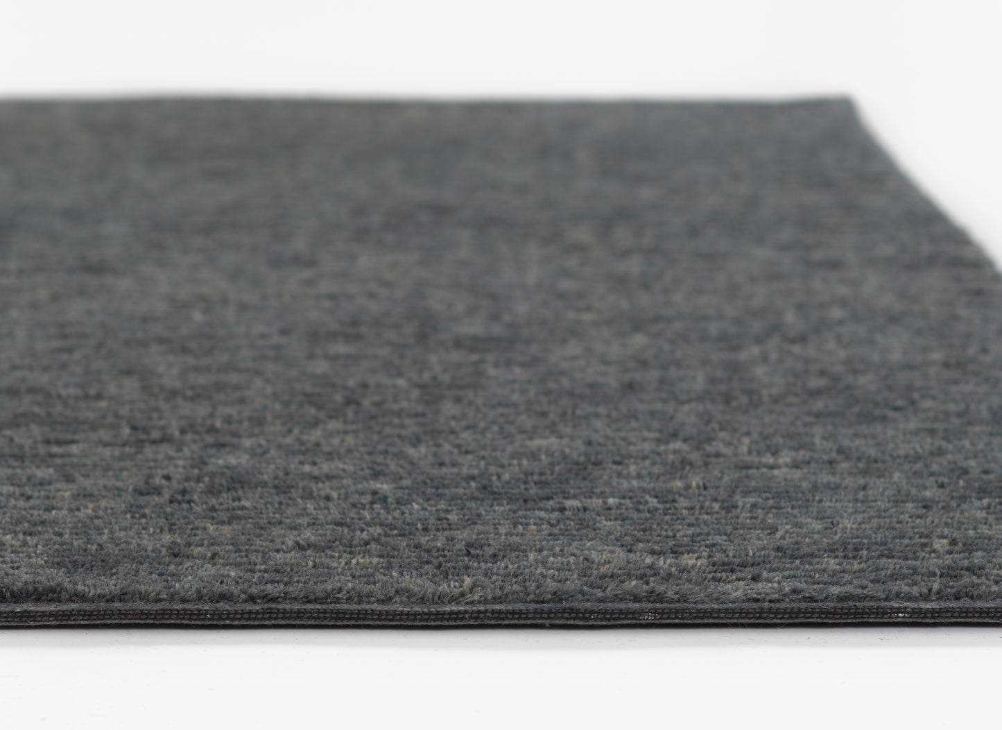 Charcoal gray rug with subtle heather texture, low pile, flat-weave look; great for living room or hallway.