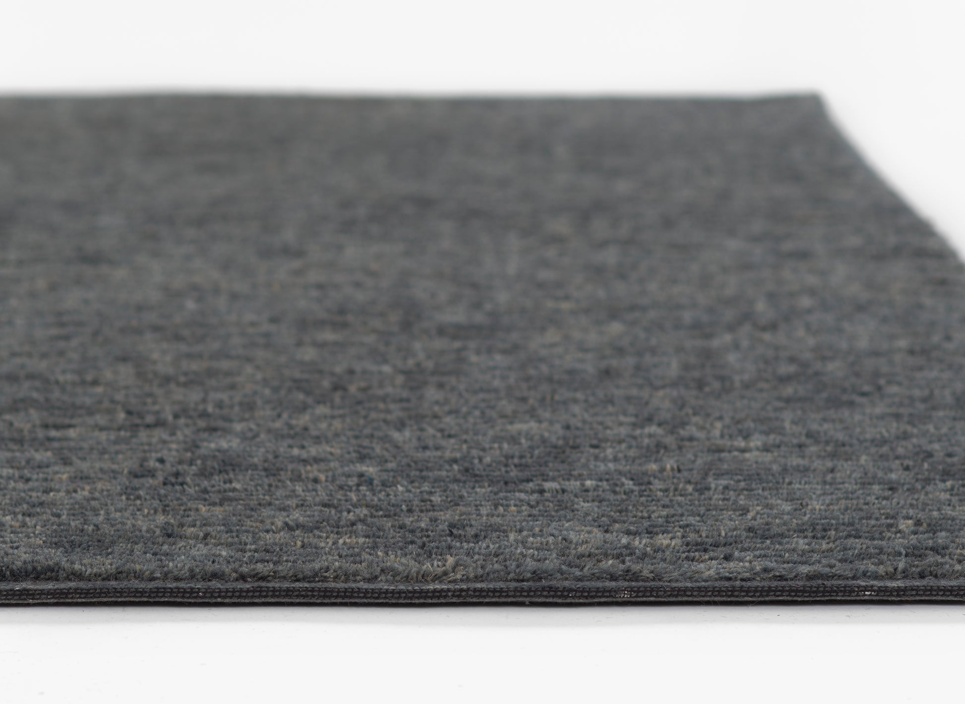 Charcoal gray rug with subtle heather texture, low pile, flat-weave look; great for living room or hallway.