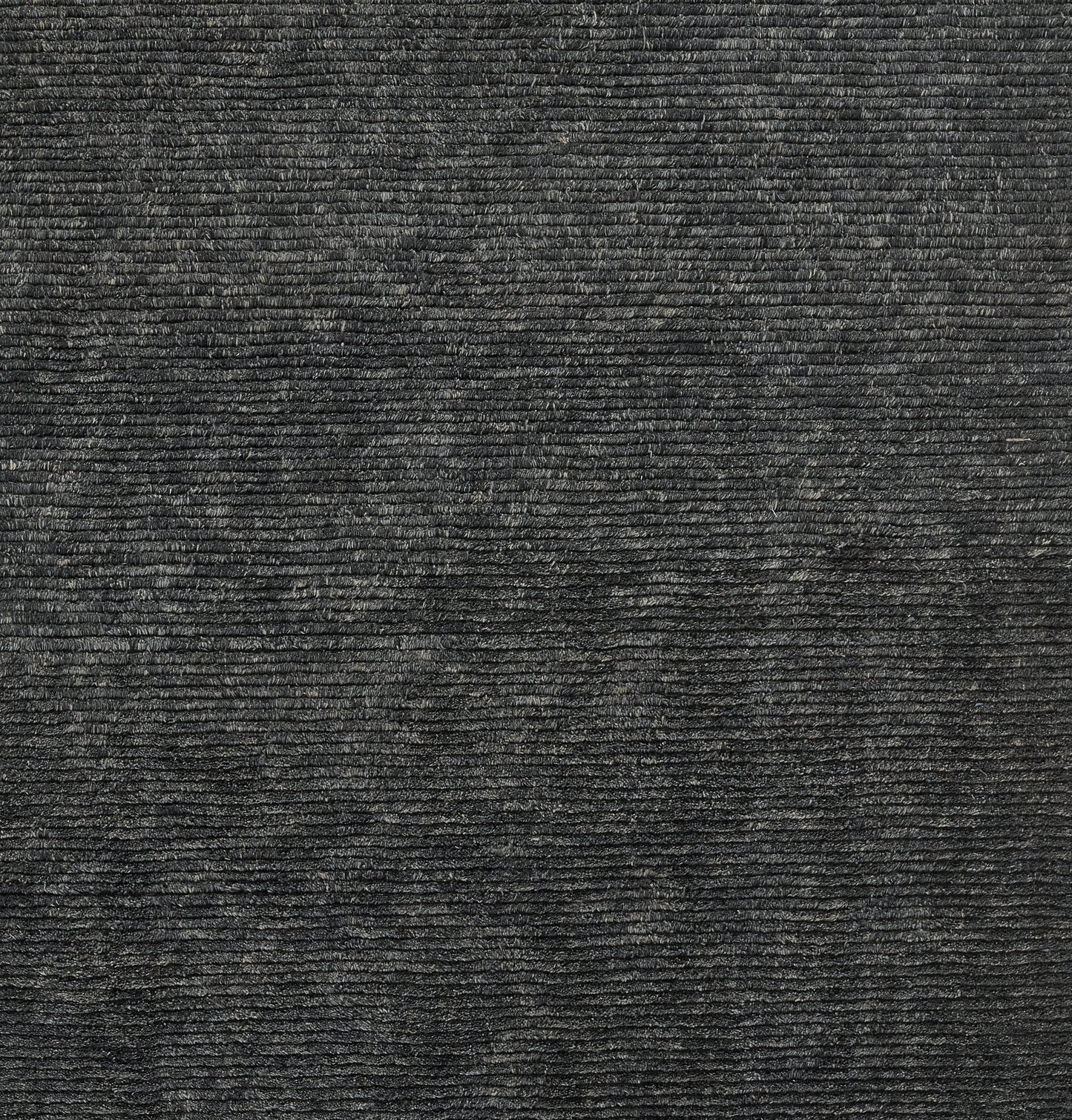 Dark charcoal rug with a ribbed texture and fine horizontal wales, corduroy-like appearance.