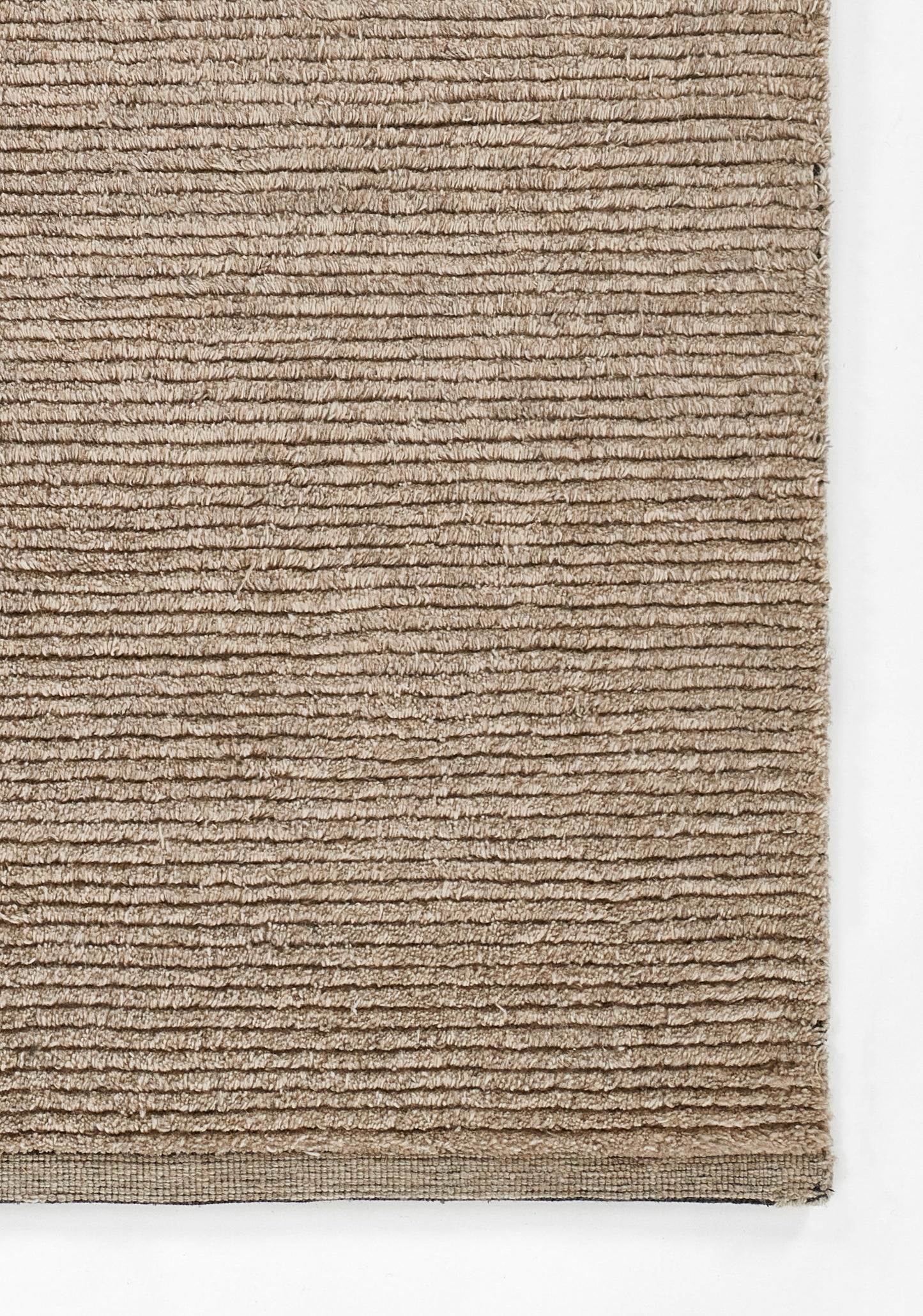 Beige ribbed rug with horizontal loop pile, soft natural tan, rectangular shape with tight edge binding.