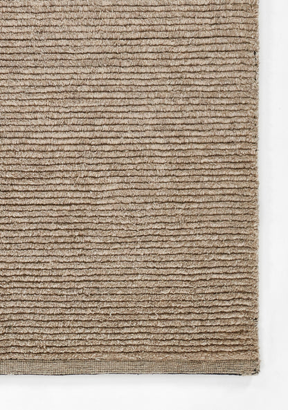 Beige ribbed rug with horizontal loop pile, soft natural tan, rectangular shape with tight edge binding.