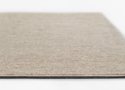 Beige natural fiber rug with a subtle woven texture, low pile, and a dark edge trim.