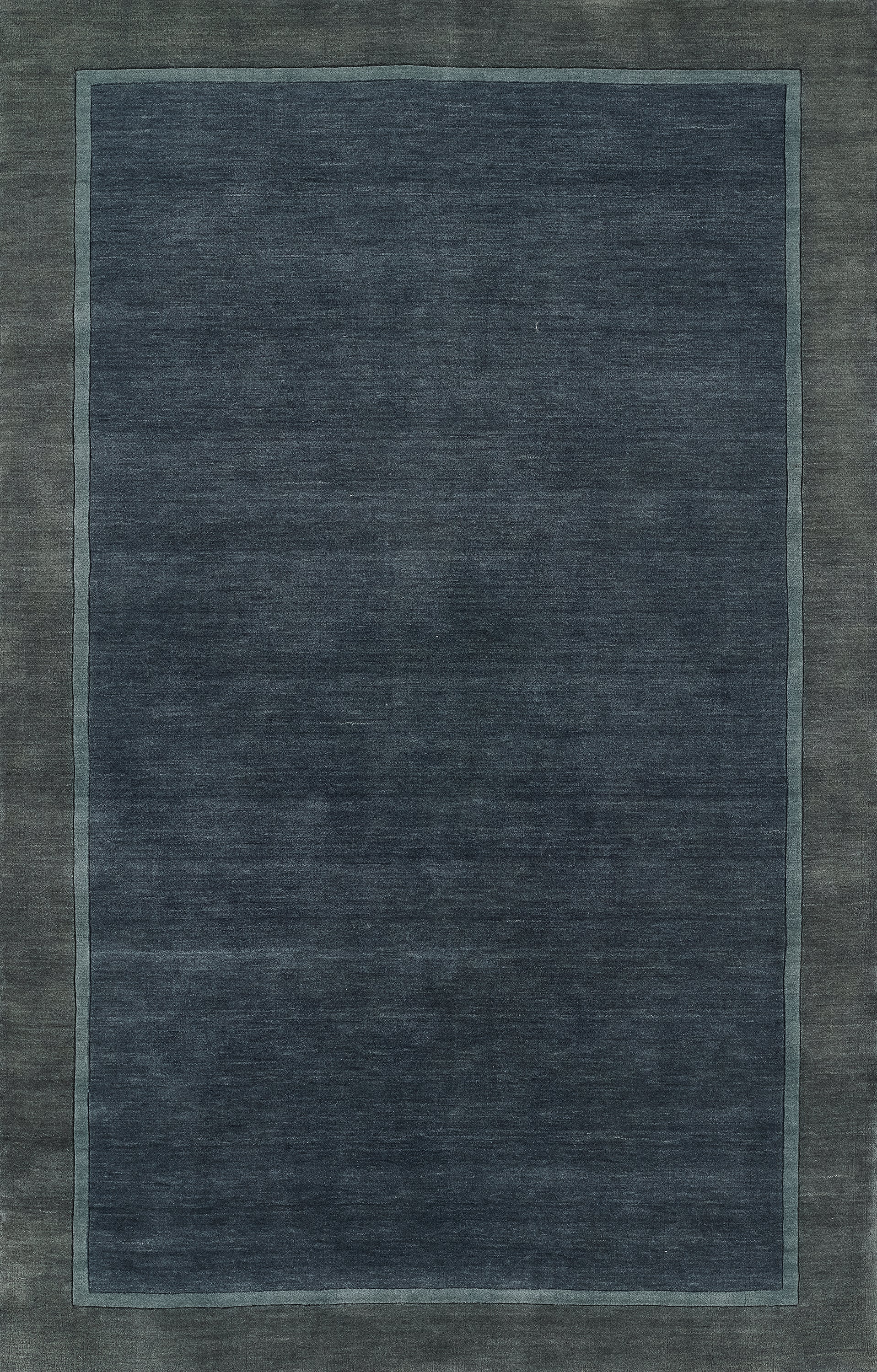 Navy blue area rug with a lighter blue inner border and muted outer edge; rectangular, modern minimalist style.