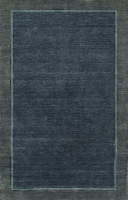 Navy blue area rug with a lighter blue inner border and muted outer edge; rectangular, modern minimalist style.