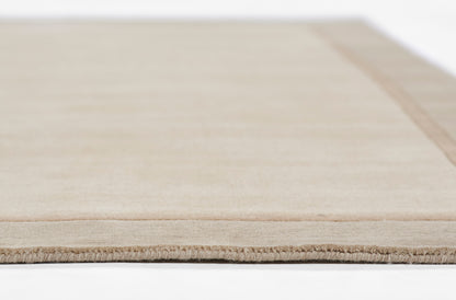 Beige taupe flatweave rug with fringe edge; low-pile, natural-fiber look for living spaces.