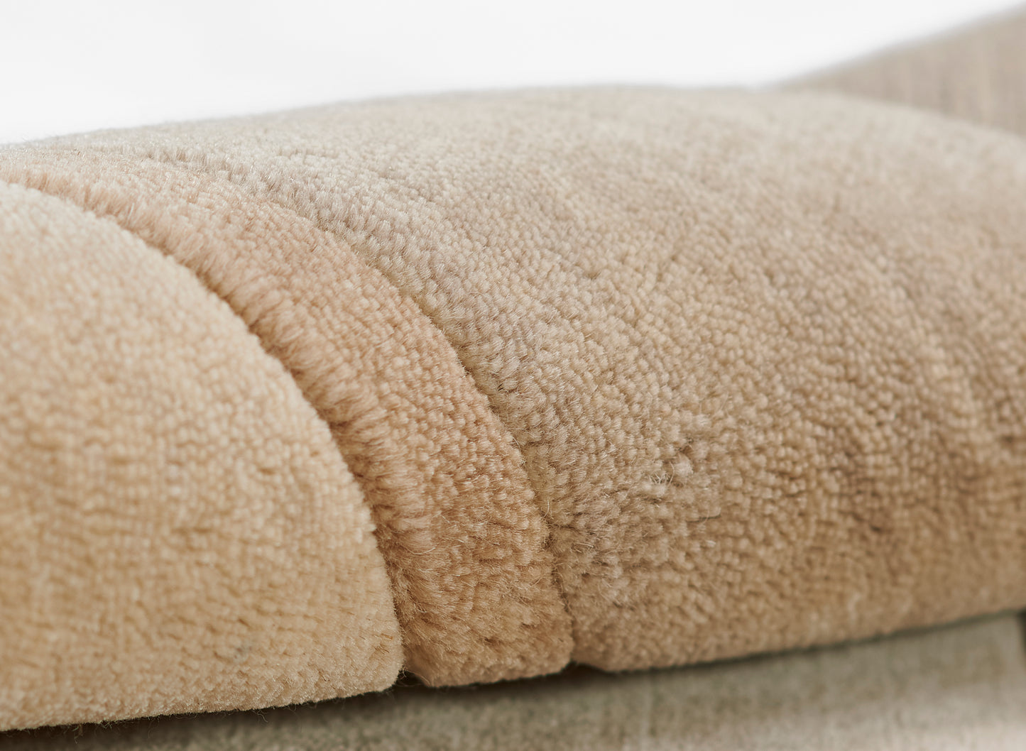 Beige taupe plush fleece blanket with thick loop pile, soft and cozy throw folds.