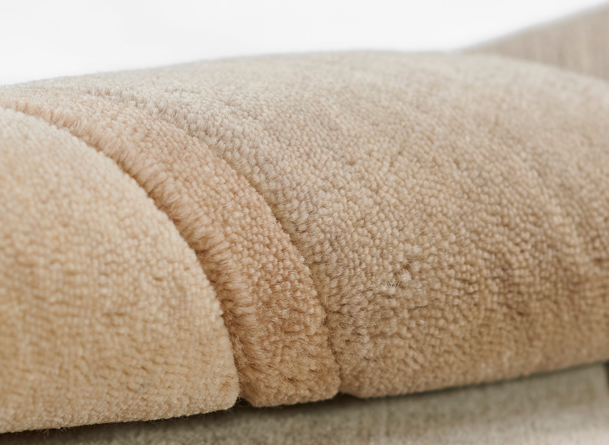 Beige taupe plush fleece blanket with thick loop pile, soft and cozy throw folds.