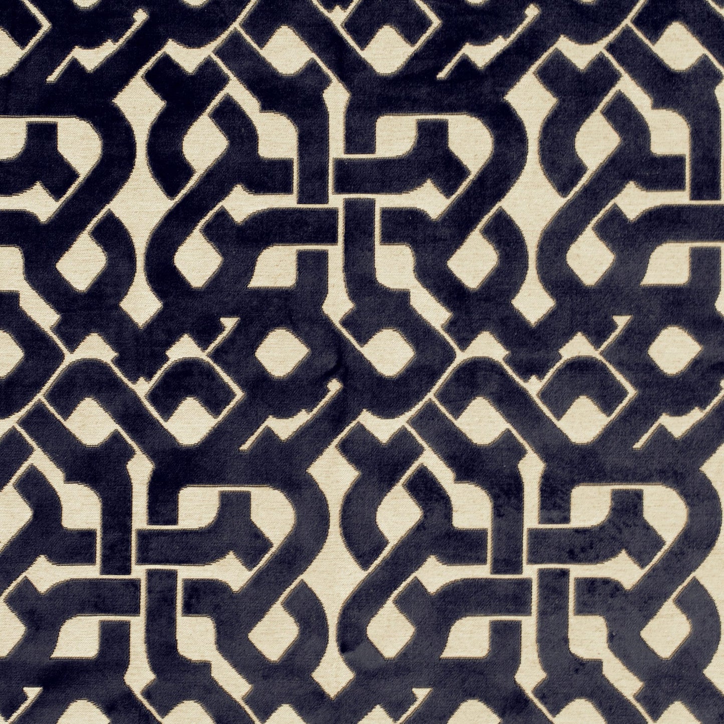 Navy and cream fabric with an interlocking geometric lattice pattern; Moroccan-inspired motif for upholstery or curtains.