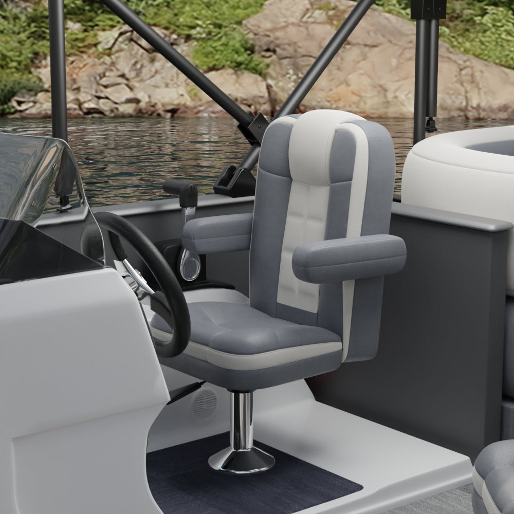 Gray solid fabric captain chair with padded armrests on a pedestal in a boat cockpit.