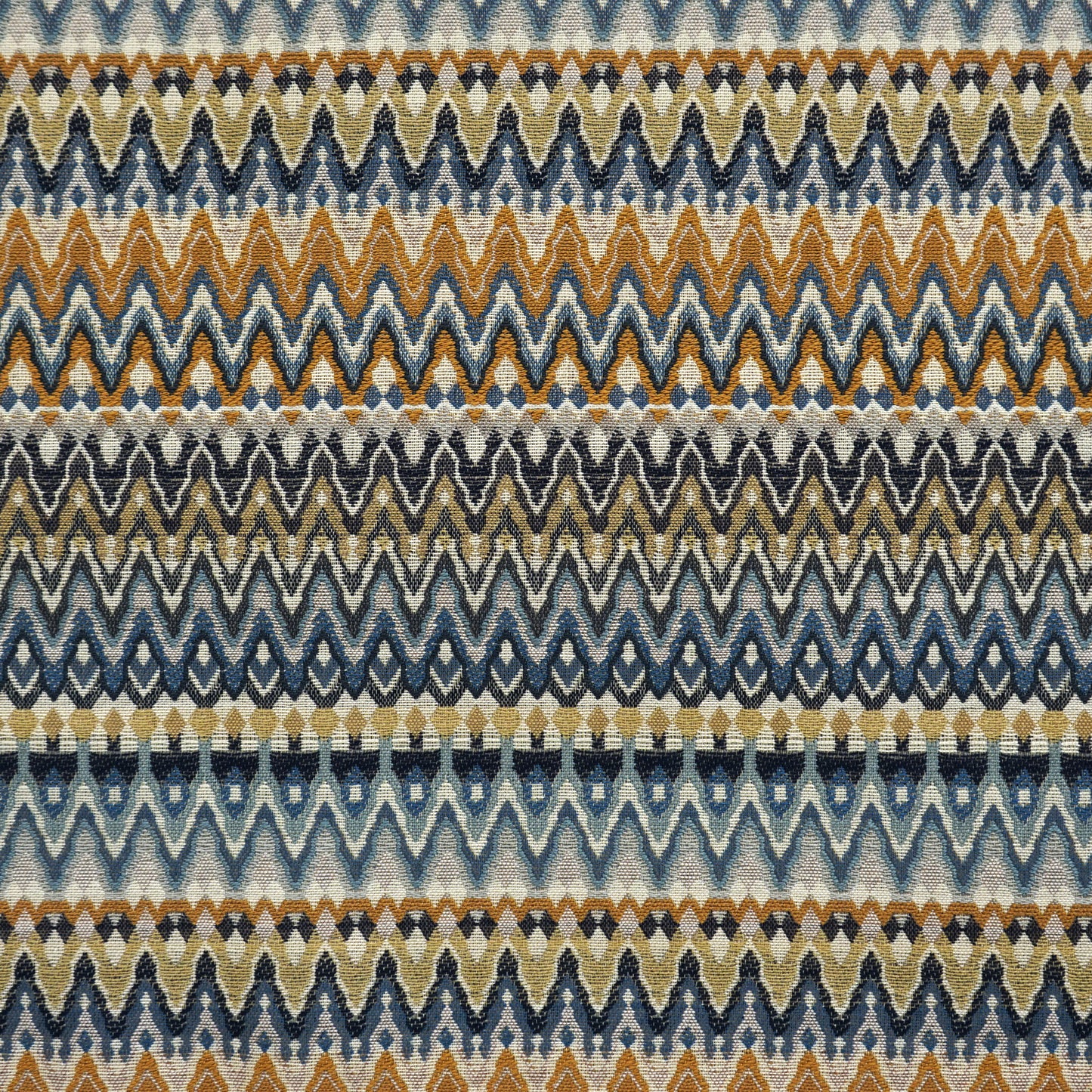 Woven chevron striped fabric in blue, creme, beige, yellow and gold tones.