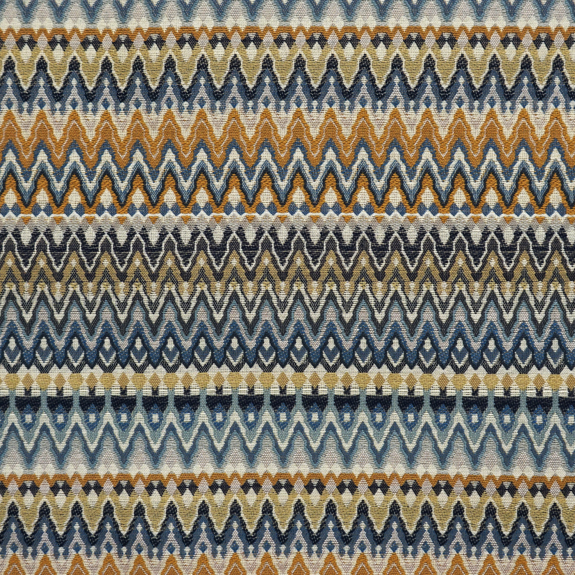 Woven chevron striped fabric in blue, creme, beige, yellow and gold tones.