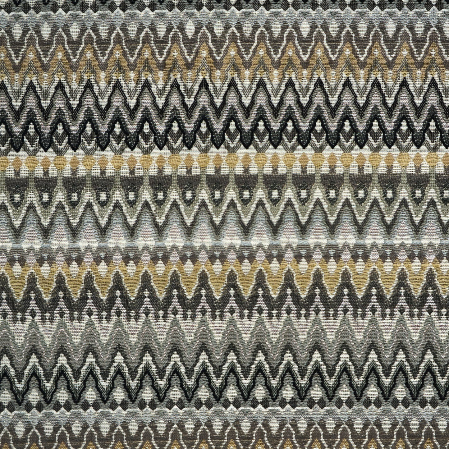 Chevron zigzag woven fabric in gray, black, beige and gold tones; repeating bands across the fabric.