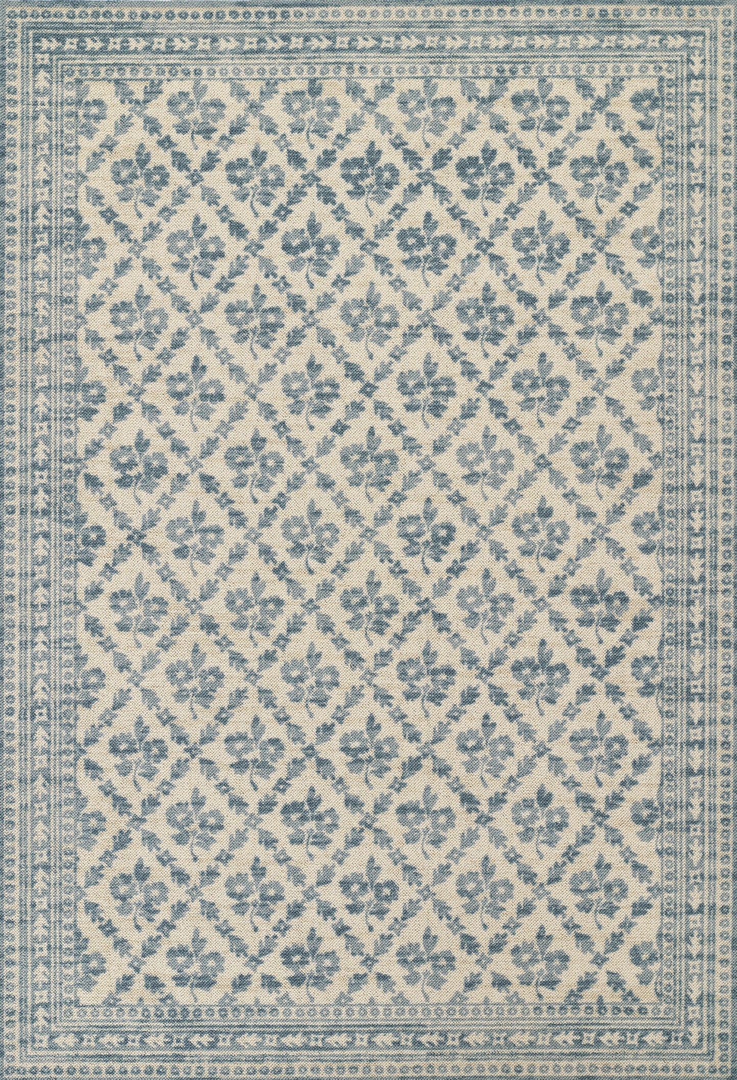Blue and ivory rectangular area rug with diamond lattice floral motif and decorative border.