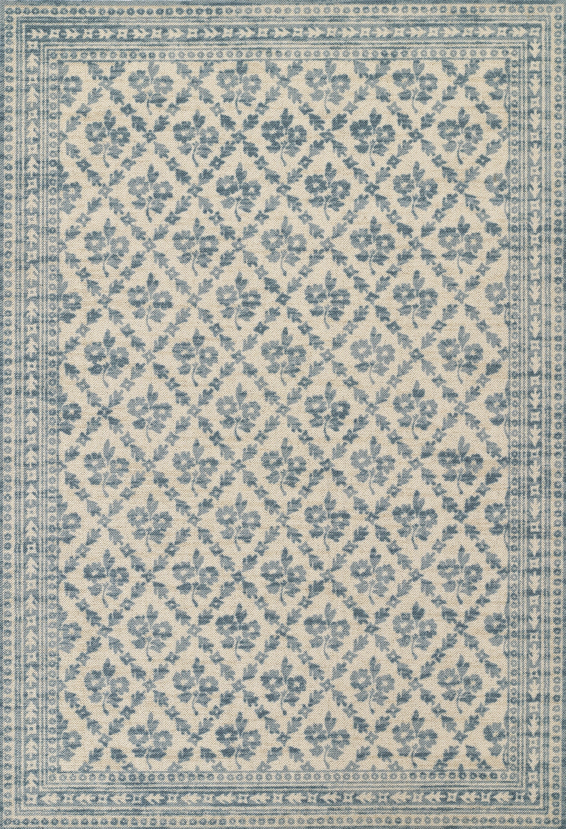 Blue and ivory rug with diamond lattice floral pattern and layered decorative borders.