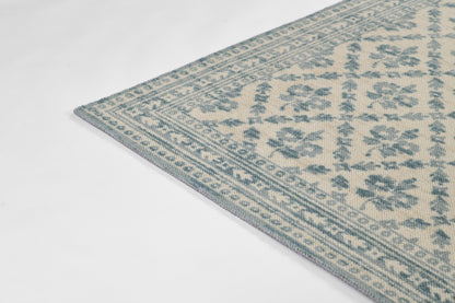Blue and cream oriental-style woven rug with floral medallion motifs and geometric border.