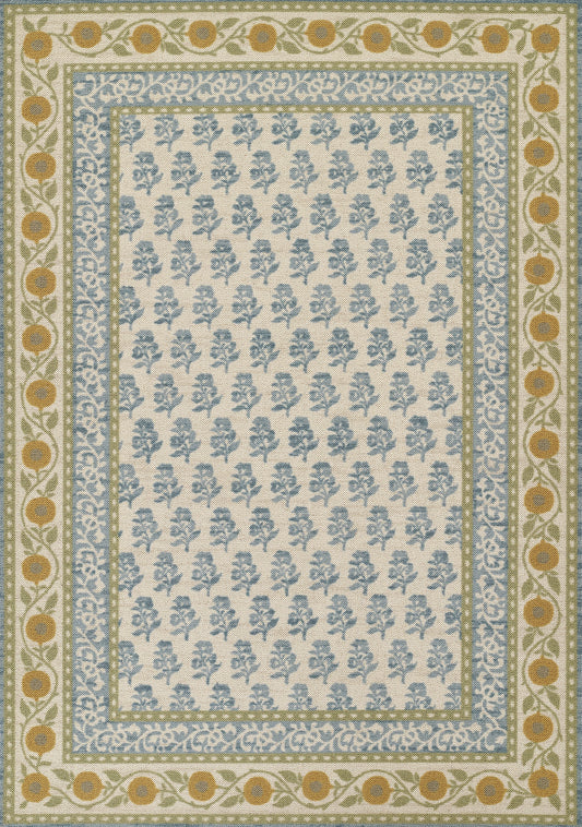 Rectangular rug with beige center and blue floral motifs; layered blue, gold, and green borders with ochre circles.