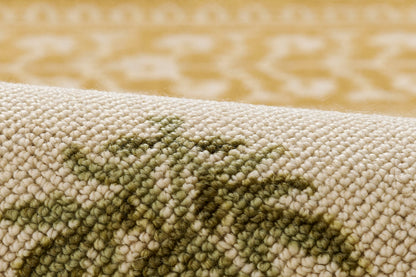 Beige loop-pile rug with olive-green abstract motif; soft woven texture for living room decor.