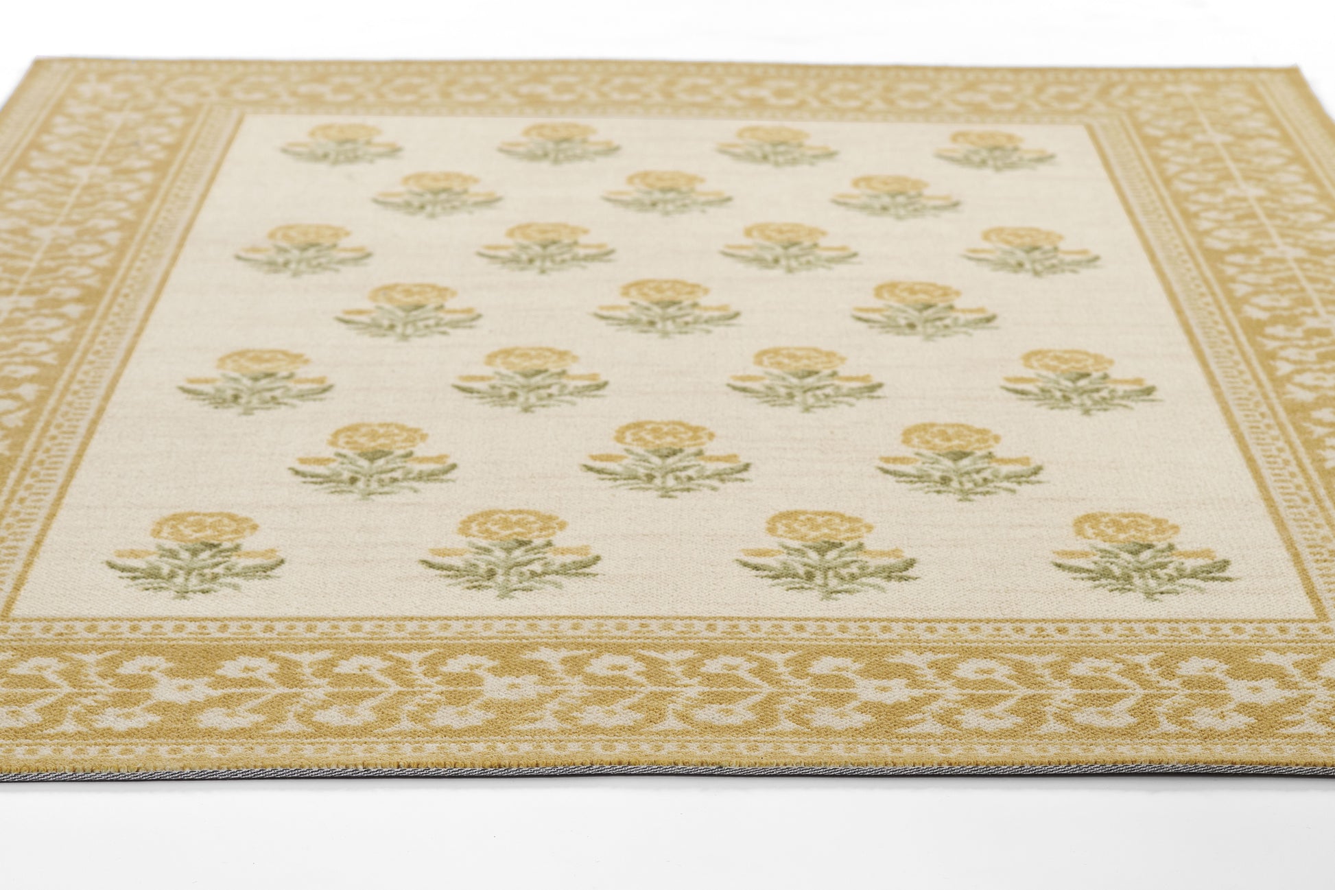 Cream field rug with yellow rose motifs and green leaves; ornate gold border and lattice trim, rectangular woven carpet.