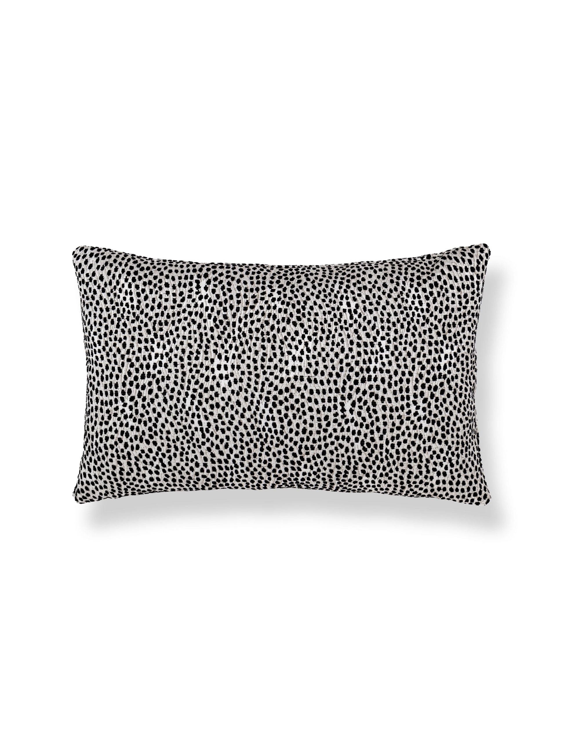 Rectangular lumbar pillow with black Dalmatian-style spots on ivory fabric, dots/circles animal-print.