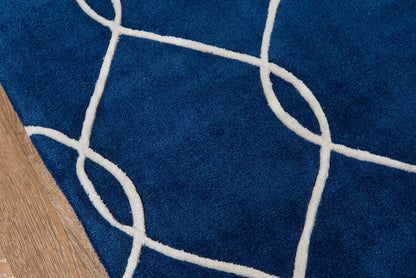 Navy blue area rug with white looping line motif on wood floor.