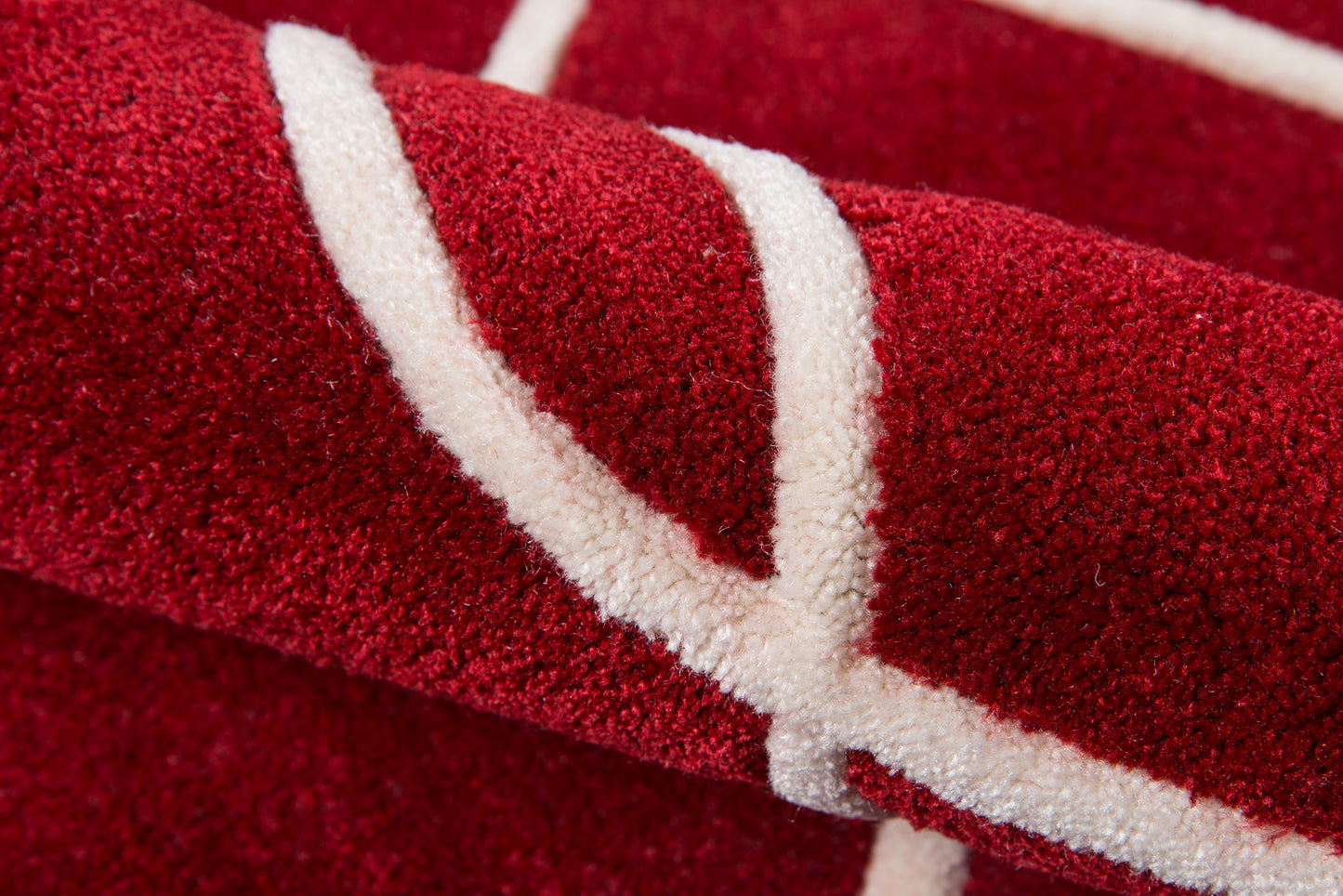 Red 2' x 8' rug runner with a white curved stripe, plush pile close-up.