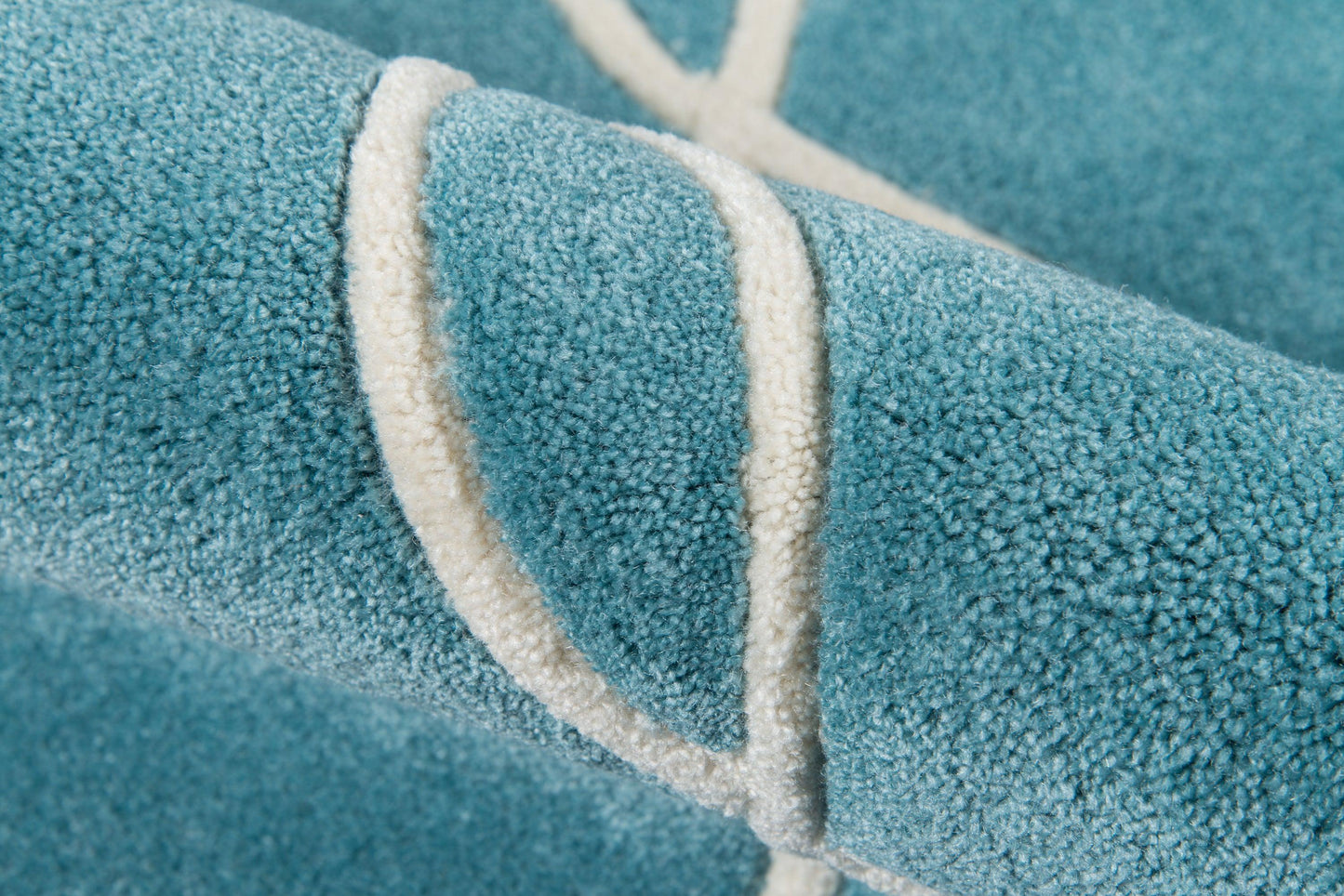 Teal blue plush rug runner with a white looped border, close-up of soft pile texture.