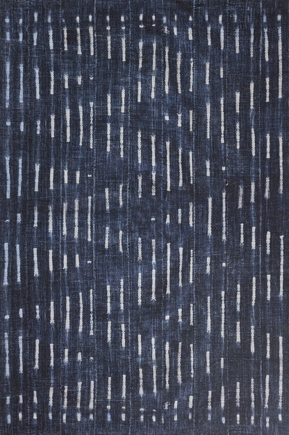 Navy blue rug with scattered white vertical dashes; modern woven textile for living room or bedroom.
