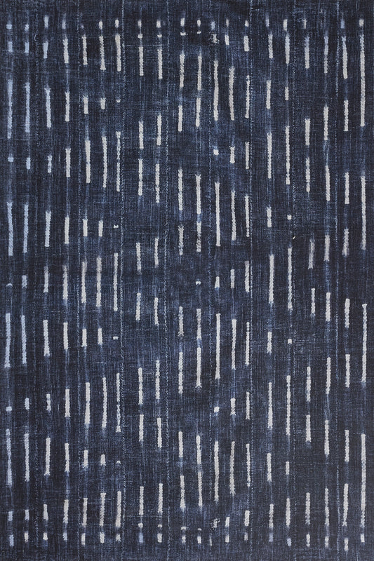 Navy blue rug with scattered white vertical dashes; modern woven textile for living room or bedroom.