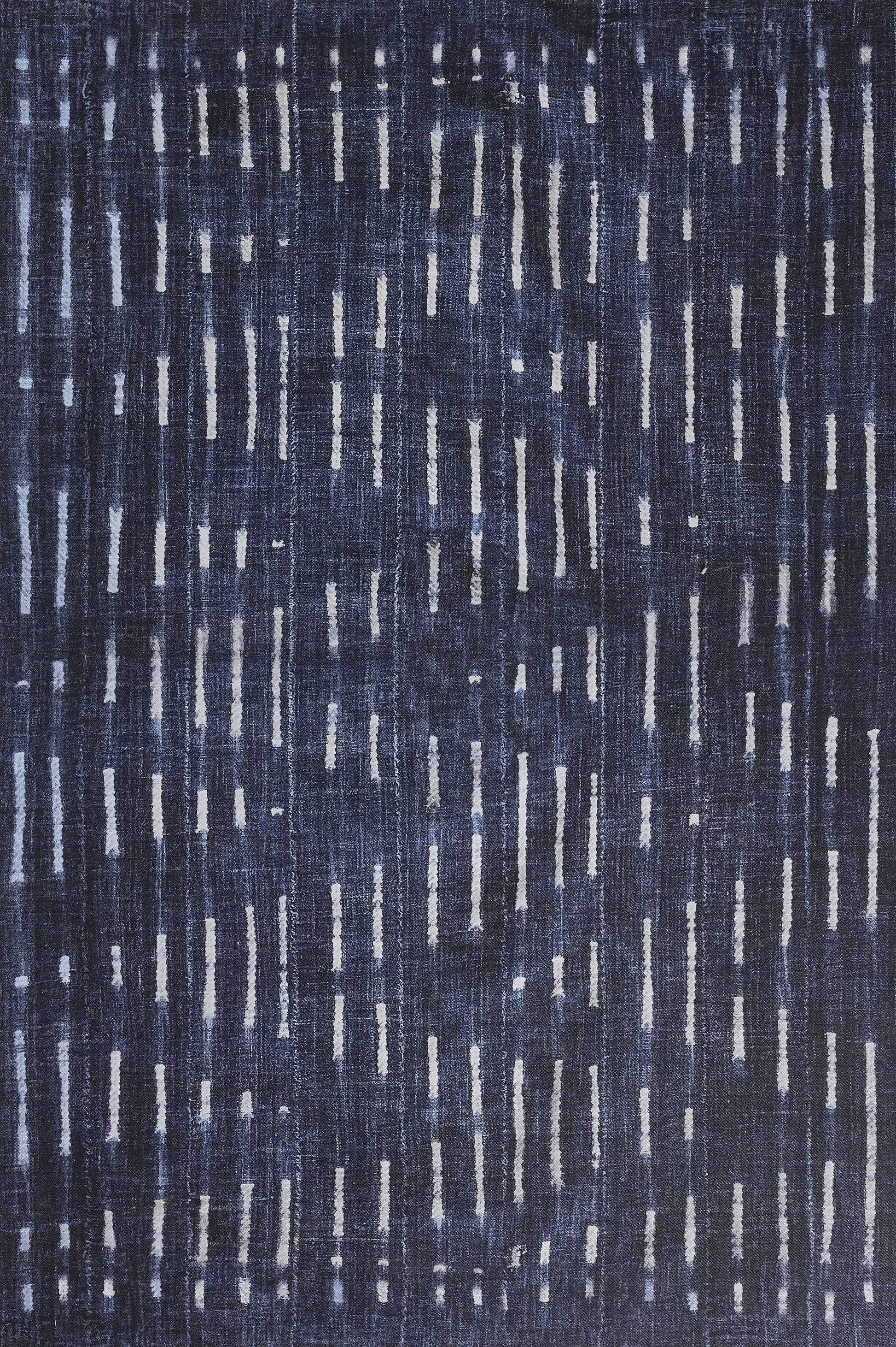 Navy blue rug with pale gray vertical dash motifs for a modern, textured, denim-inspired look.