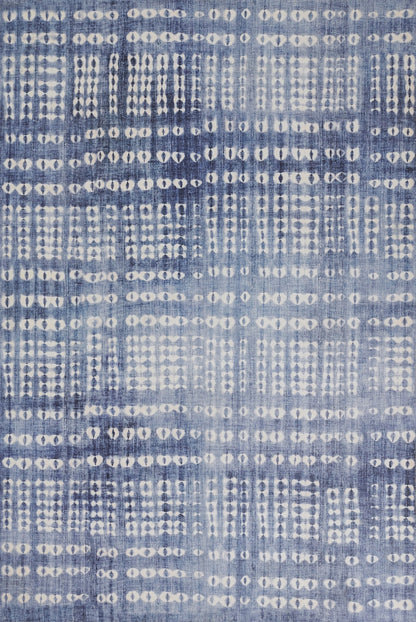 Denim-blue woven rug with a white dotted grid pattern and an abstract geometric design.