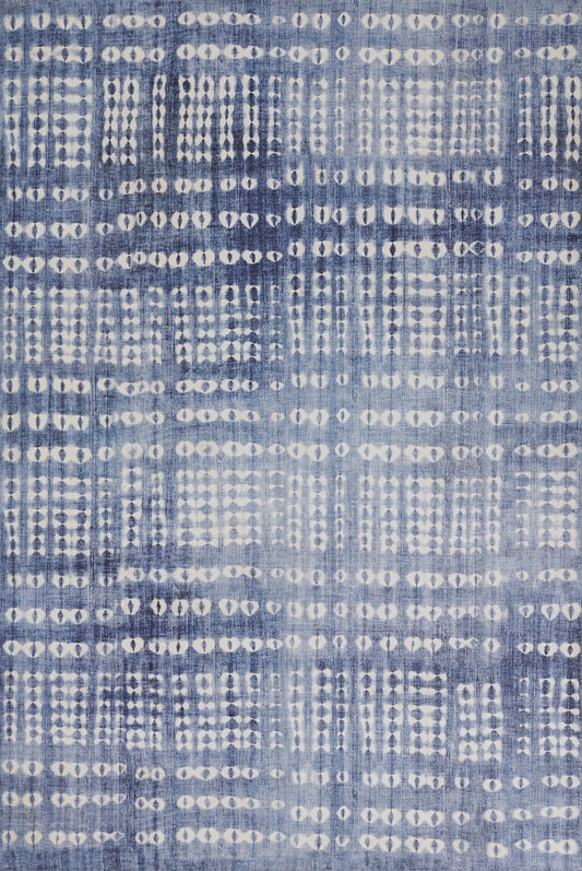 Denim-blue woven rug with a white dotted grid pattern and an abstract geometric design.