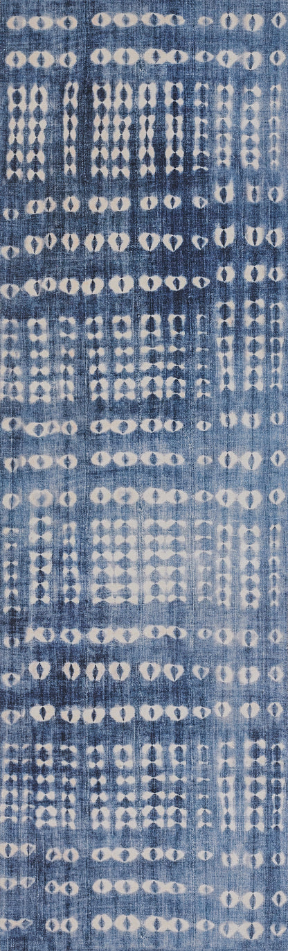 Indigo blue rug with white diamond-dot ikat motifs.