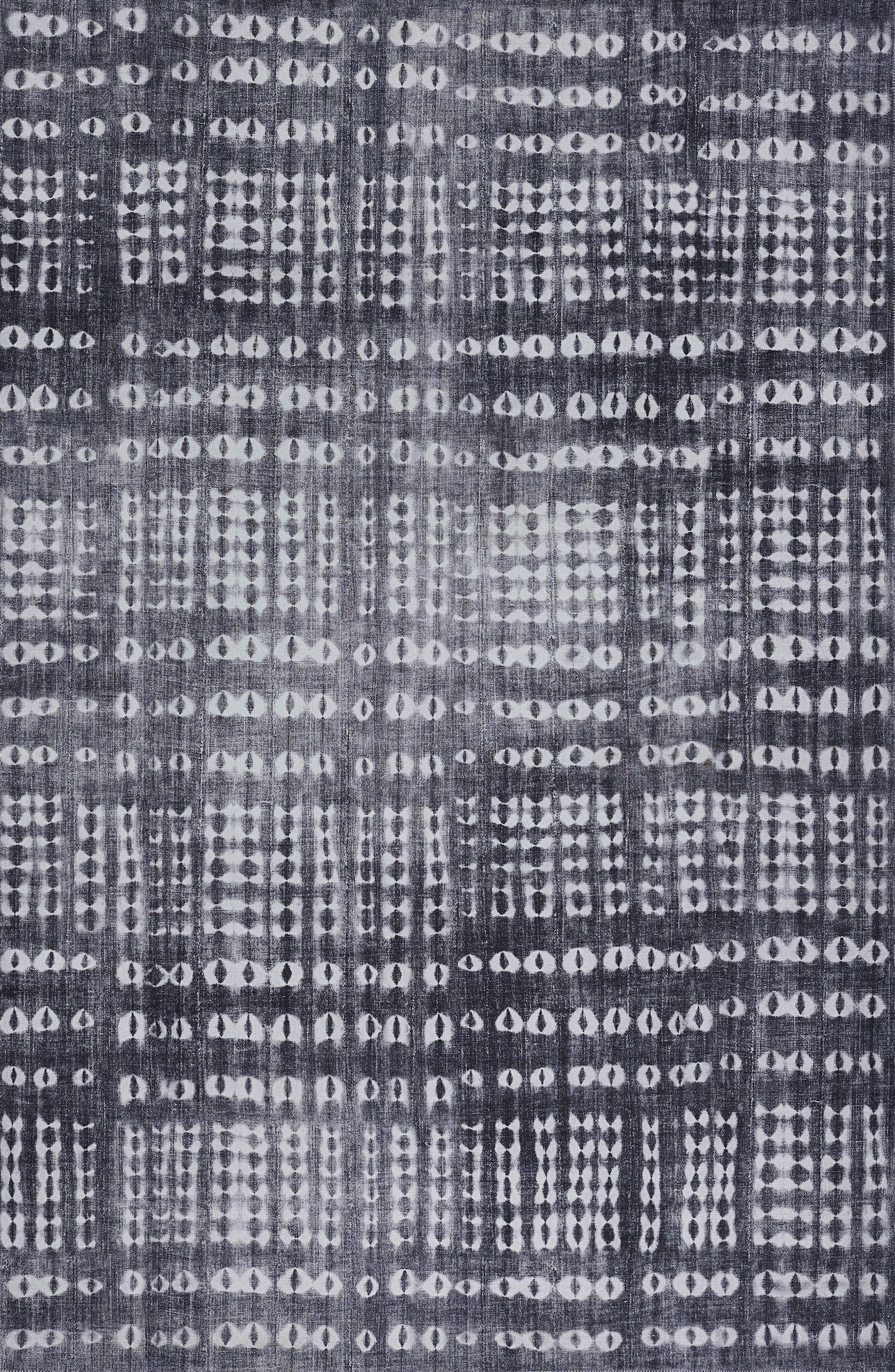 Indigo woven fabric with irregular white dot grids; batik/ikat-inspired decorative textile.