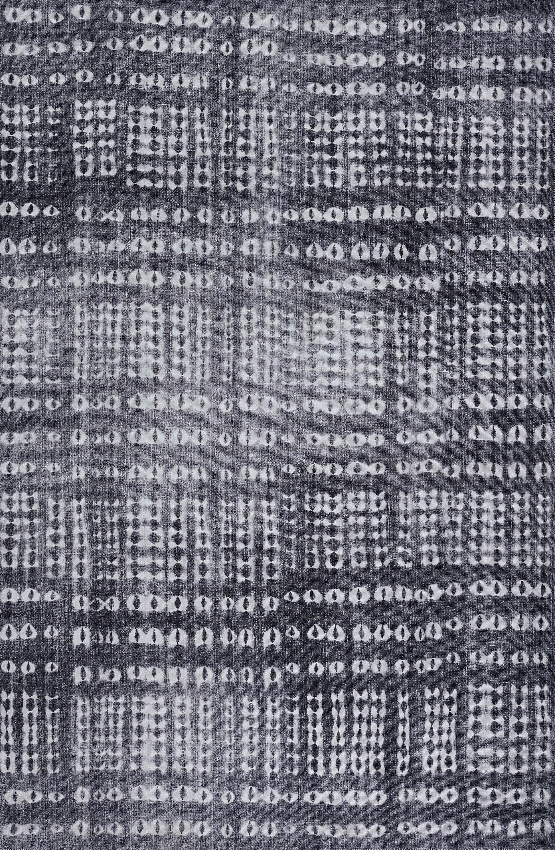 Indigo woven fabric with irregular white dot grids; batik/ikat-inspired decorative textile.